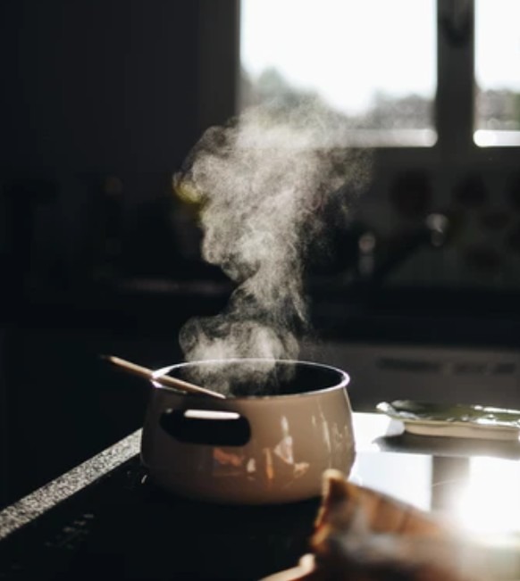 steam coming out of a pot of rice