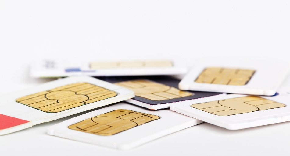 Sims scattered around on a white table