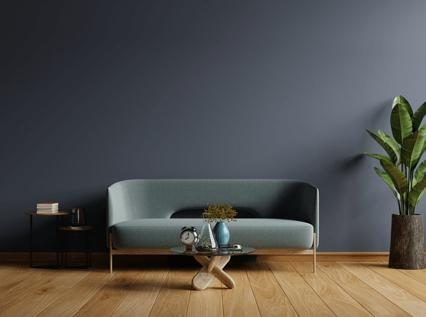 Interior of lightroom with sofa on empty dark blue wall