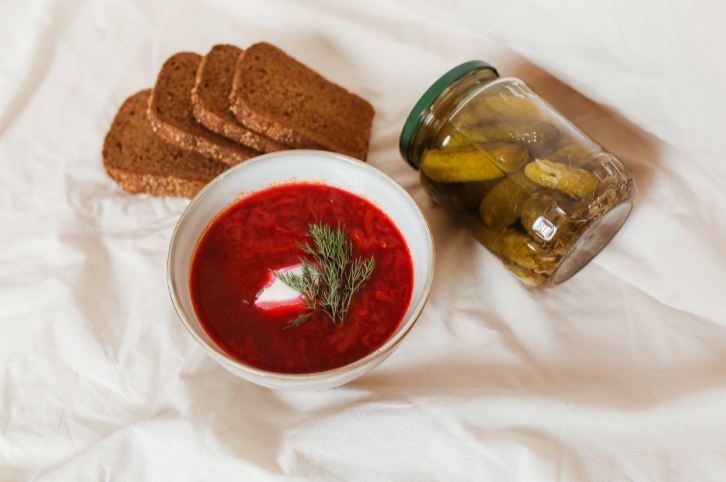 Borscht soup with bread and pickles.