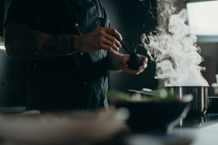 A man cooking soup in a pot