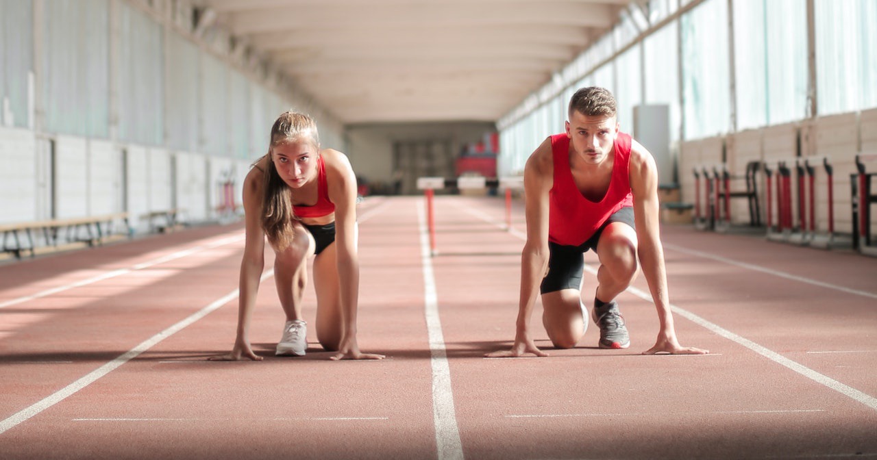 Young athletes preparing for running in training hall.