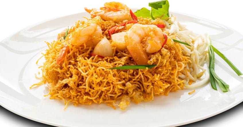 crispy noodles with shrimp, bean sprout, and garlic in a white ceramic plate