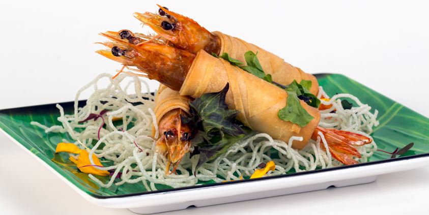 wrapped fried shrimps and crispy fried noodles on a plate