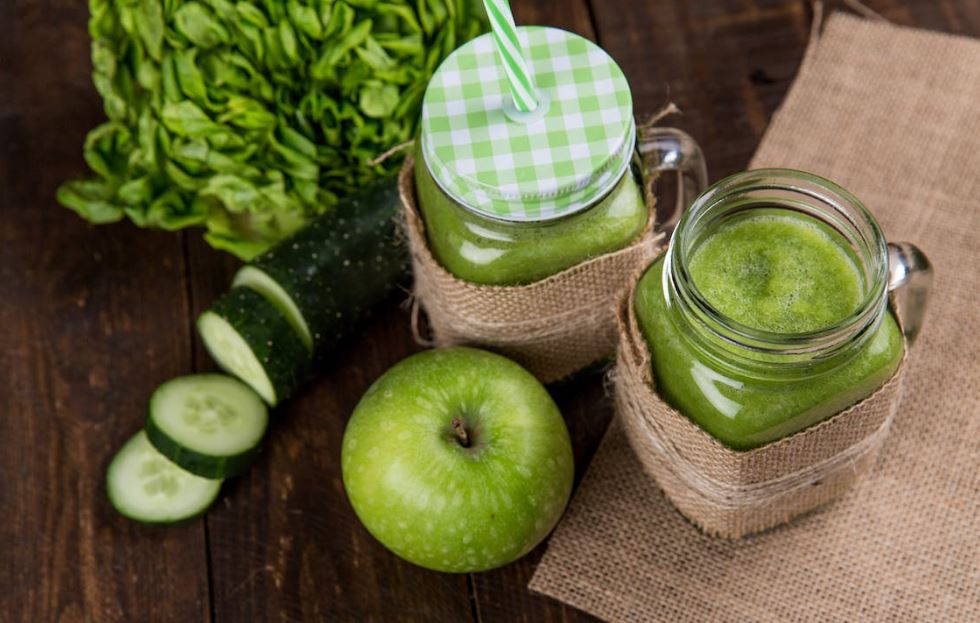 Green apple beside of two clear glass jars