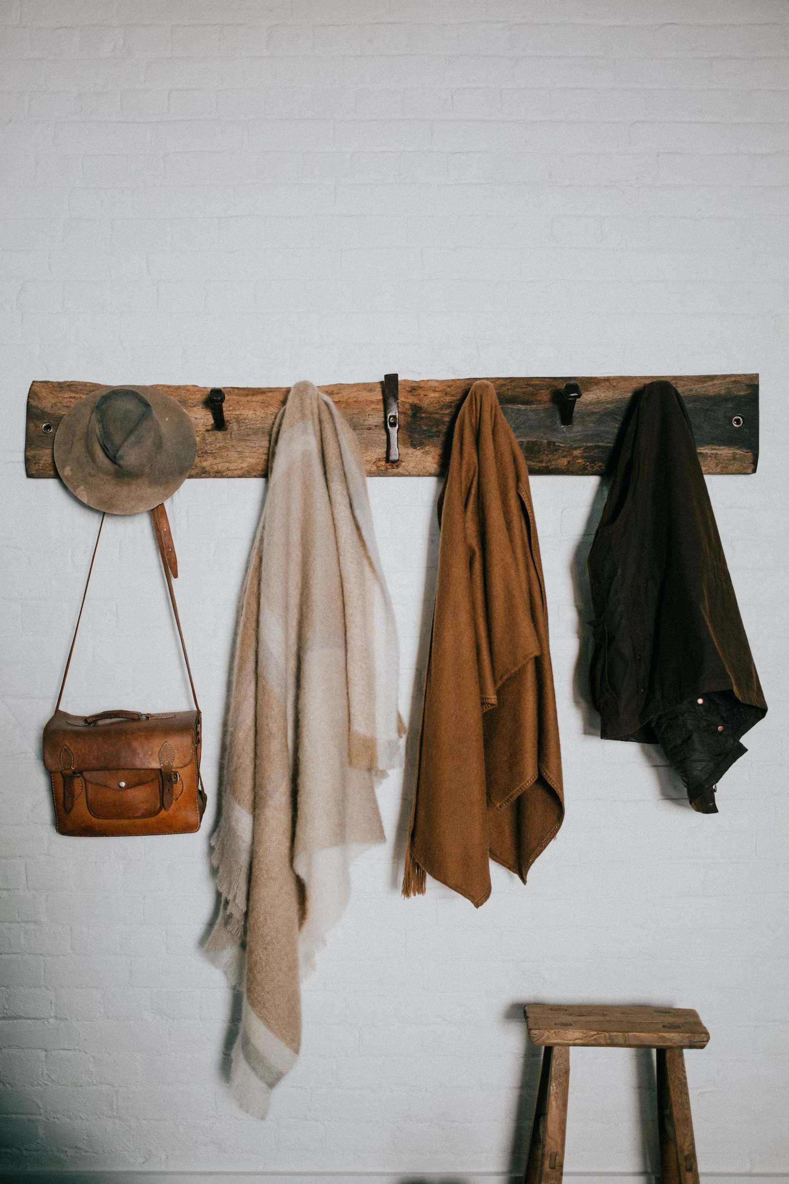 Brown and beige bath towel hung on a brown wooden hook